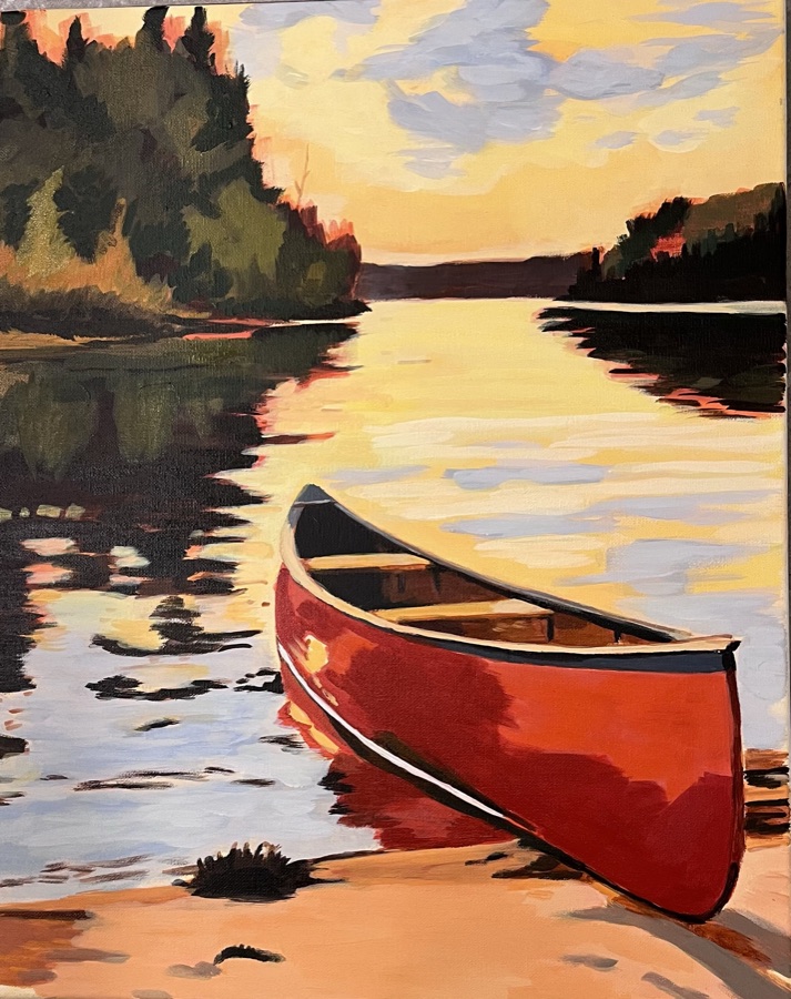 A bright red canoe on a sandy shore at sunset, with reflective golden water and a forested shoreline behind.